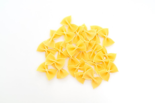 Dry uncooked farfalle pasta isolated on white background