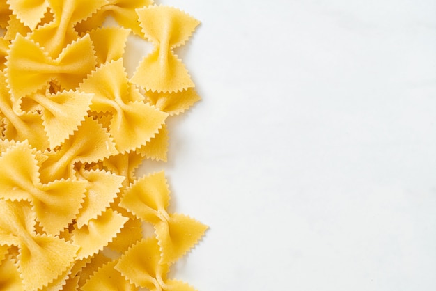 Dry uncooked farfalle pasta with copy space