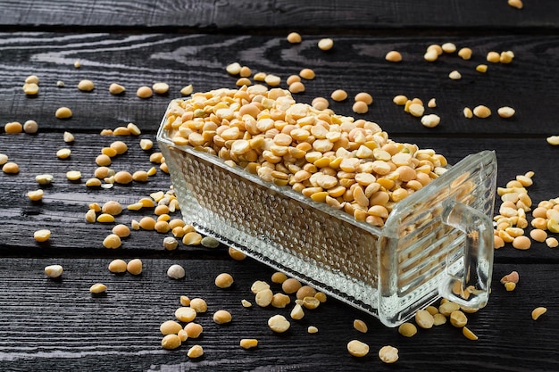 Dry yellow peas in a glass ladle