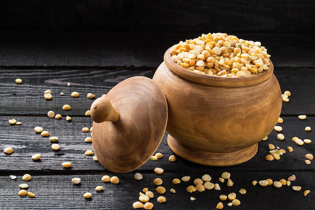 Dry yellow peas in a wooden pot