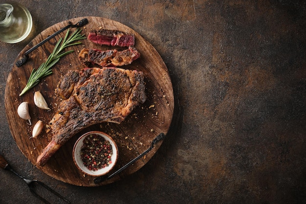 Dryaged marble beef steak Tomahawk on wooden board with spices Flat lay dinner concept