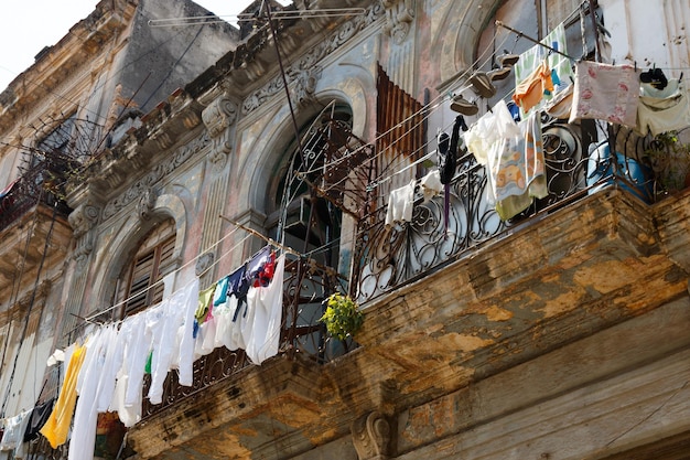 Drying clothes on an old shabby balcony in Havana city