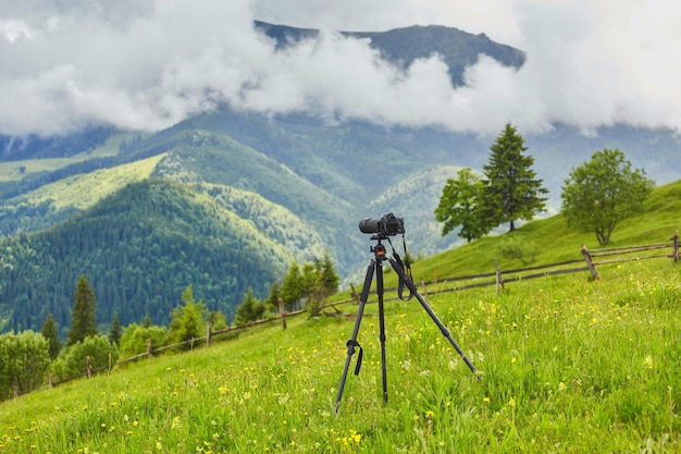 Dslr digital professional camera stand on tripod photographing mountain Blue sky and cloud landscape