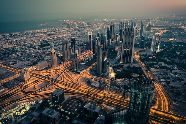 Dubai downtown night scene with city lights. Top view from above