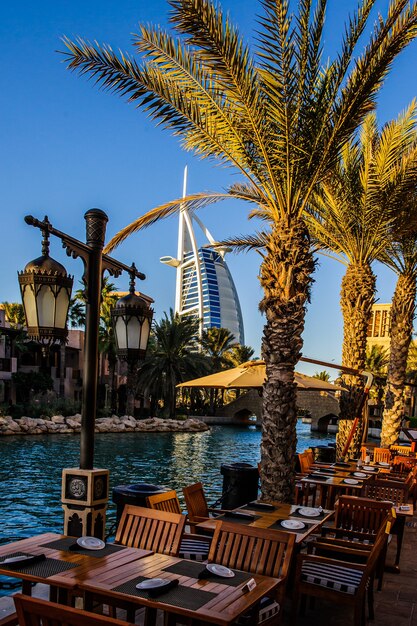 Photo dubai, uae - 10 october 2017: view for burj al arab hotel from the madinat jumeirah in dubai, uae. burj al arab with 321 meters high is the most luxurious 7 star hotel and a symbol of modern dubai.