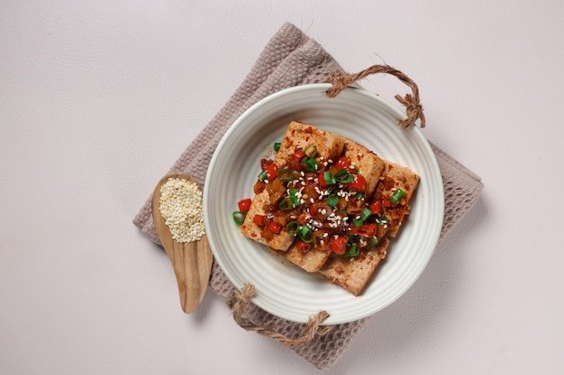 Dubu Jorim is a Korean Braised Tofu. Fried Tofu with Soy Sauce and chillies.