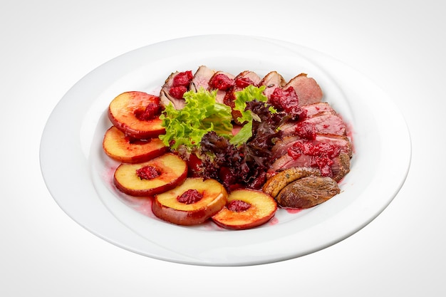 Photo duck breast mangre with berry confit and baked apple on a white background