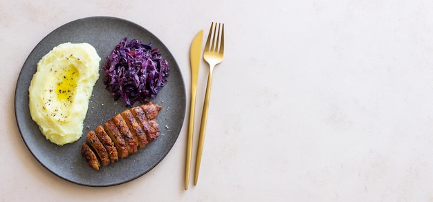 Duck breast with mashed potatoes and red cabbage