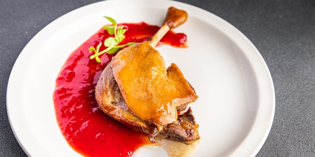 duck confit leg, red berry sauce  meal food snack on the table copy space food background