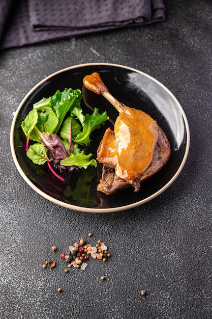 duck confit meat leg, red berry sauce  meal food snack on the table copy space food background