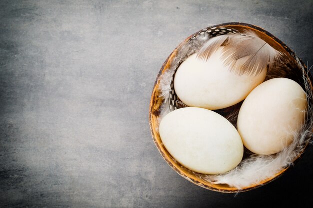 Duck eggs on a cage grey table.