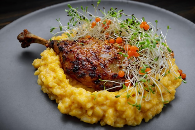 Duck leg with risotto pumpkin and herbs