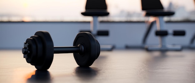 Dumbbell is on a gym floor over blurred modern fitness gym in the background