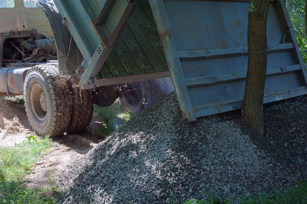 Dump trucks carrying good filling a field giving rise to a fine soil Preparation and construction