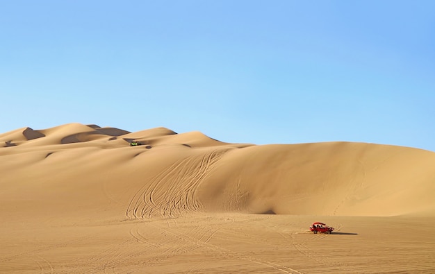 Dune buggies running on the amazing Huacachina sand dunes in Ica region, Peru, South America