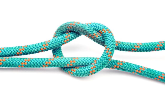 Durable colored rope for climbing equipment on a white background knot of braided cable item for tourism and travel