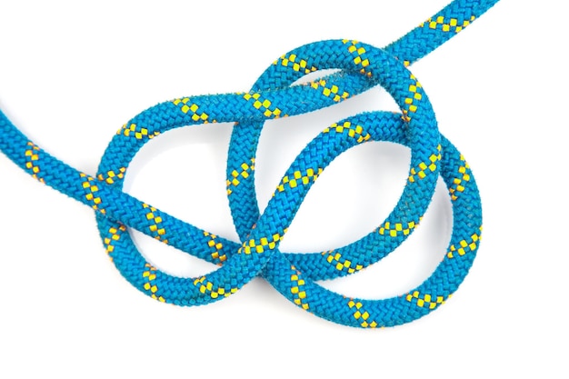 Durable colored rope for climbing equipment on a white background knot of braided cable item for tourism and travel