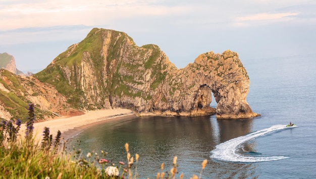 Durdle Door rock arch and the North Sea at sunset in summer UK