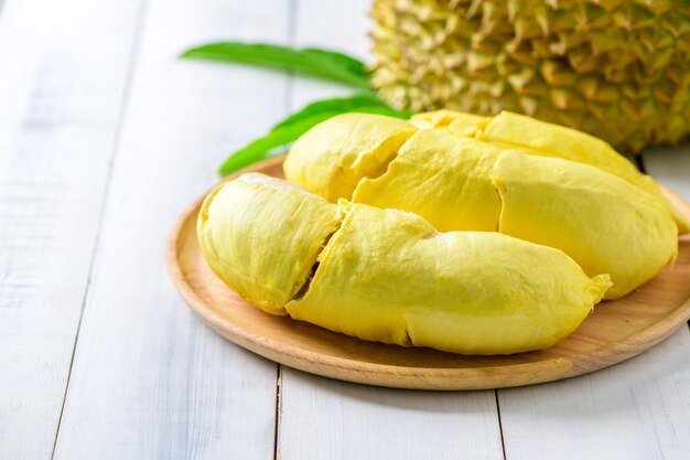 Durian fruit Ripe monthong durian on wood plate and white wood background king of fruit from Thailand