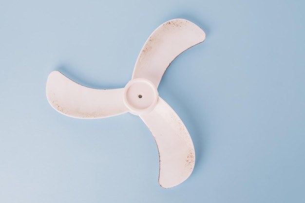 Dusty dirty ventilation fan isolated on blue background