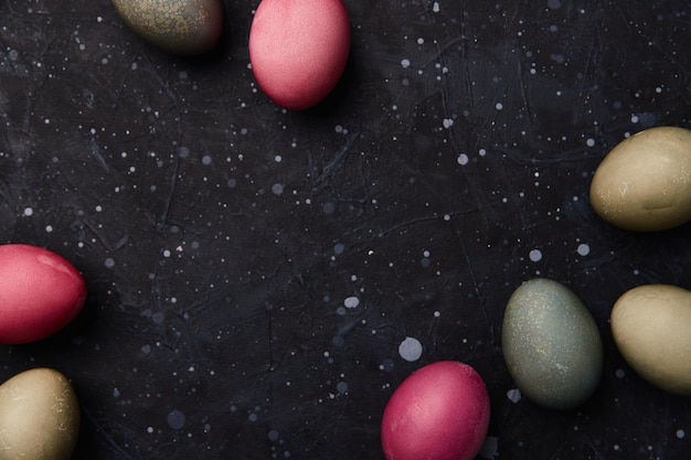 Dyed eggs on black background easter celebration concept