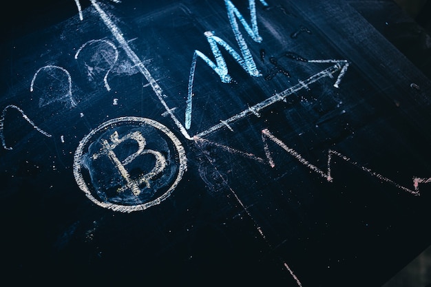 dynamics of changes in the price of bitcoin cryptocurrency drawing on a chalk board