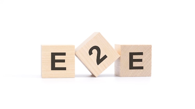 E2E acronym from wooden blocks with letters questions and answers concept top view on white background