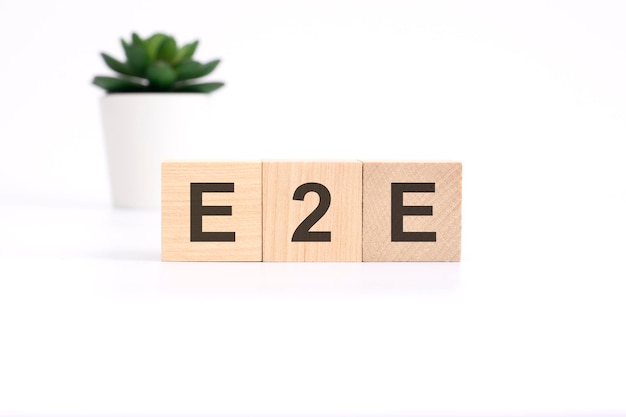 E2E exchange to exchange acronym on wooden cubes on white background business concept