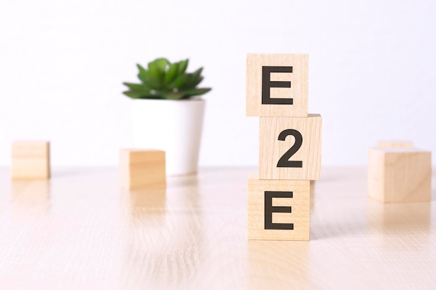 E2E Exchange to Exchange text on wooden cubes on a white background