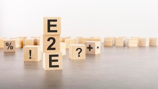 E2e text as a symbol on cube wooden blocks many wooden blocks with symbol in the background