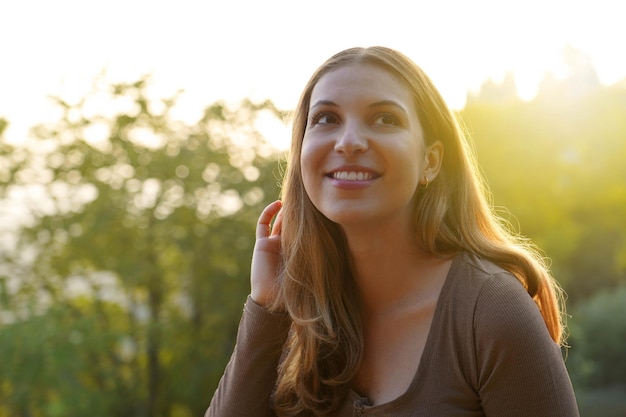 Early morning girl enjoying the first rays of sunshine of the day in nature