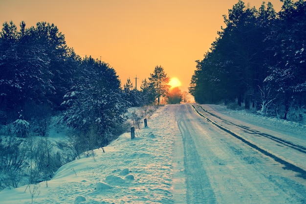 Early morning, road covered with snow at sunrise