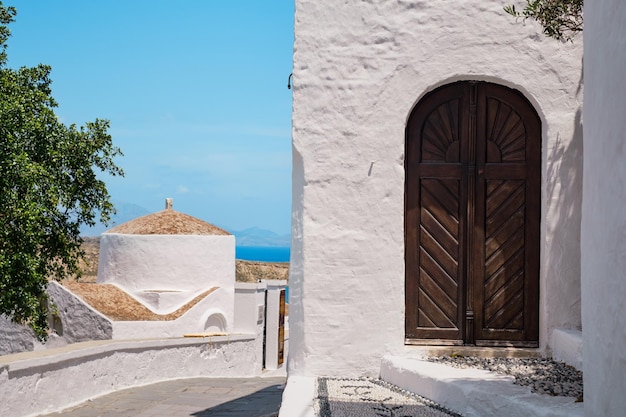 Early morning St George church in Lindos town Rhodes island Greek islands of Dodecanese archipelago Europe Leisure and travel around the islands a popular tourist destination