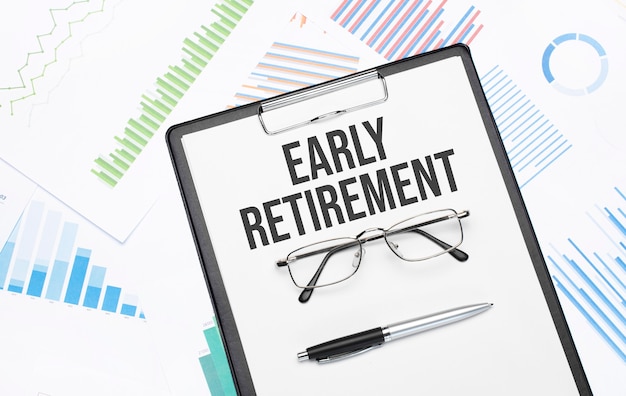 EARLY RETIREMENT sign. Conceptual background with chart ,papers, pen and glasses