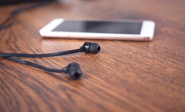 Earphone and smart phone on the table