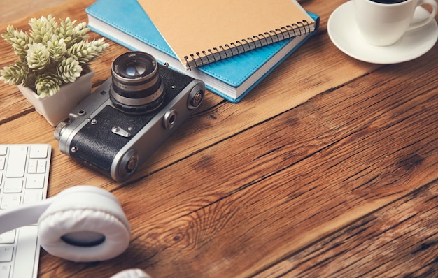 Earphone with keyboard and notepad with camera on table