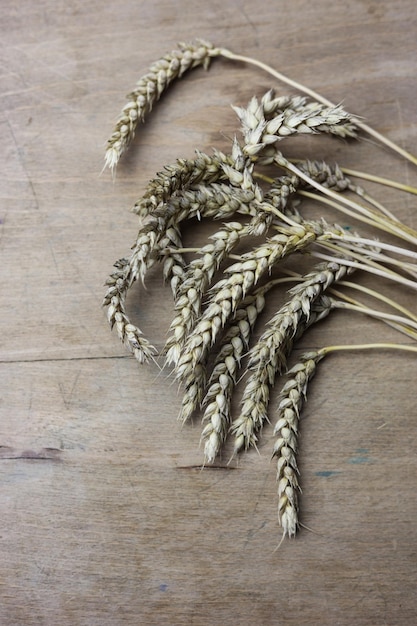 ears of wheat on a wooden table