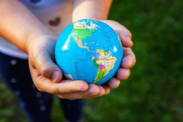 Earth globe in children hands