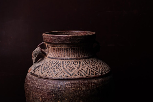 Earthenware jug standing on dark room