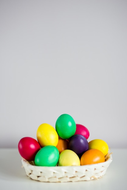 Easter background colorful eggs on the table with copy space over wall