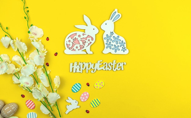 Easter background, spring greeting card with happy easter text on a yellow paper, top view photo