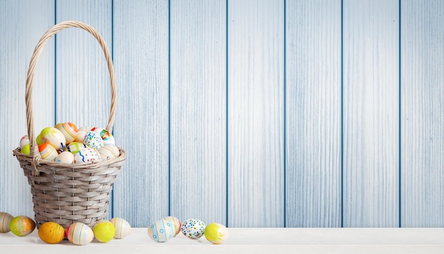 Easter background with colorful easter eggs on wooden background