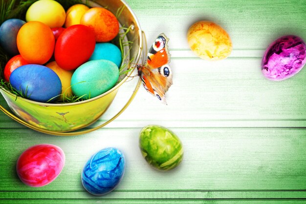 Easter background with colorful easter eggs on wooden background