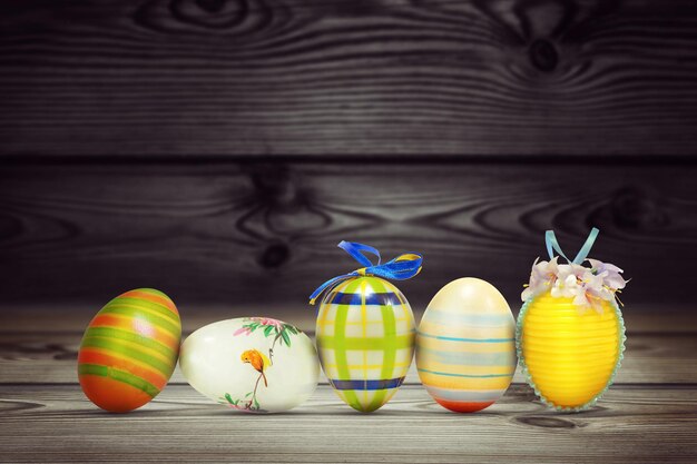 Easter background with colorful easter eggs on wooden background