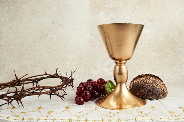 Easter background with crown of thorns and chalice with red wine as concept for christ blood