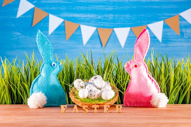 Easter background with eggs rabbits and green grass