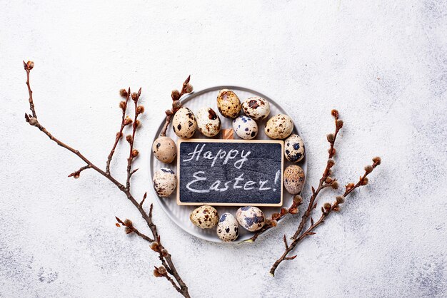 Photo easter background with quail eggs and pussy willow