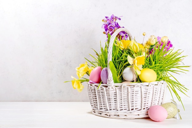 Easter basket with spring flowers and eggs