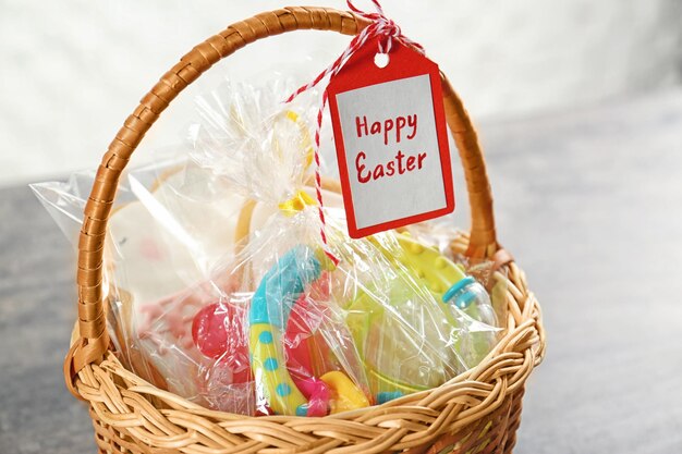 Easter basket with toy cookies and greeting card close up