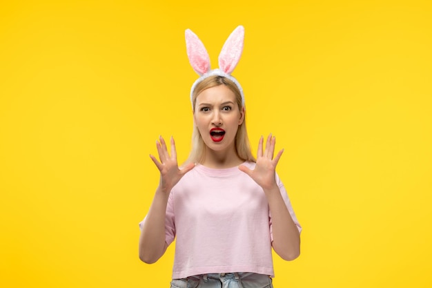 Easter beautiful cute blonde girl with bunny ears angry with waving hands